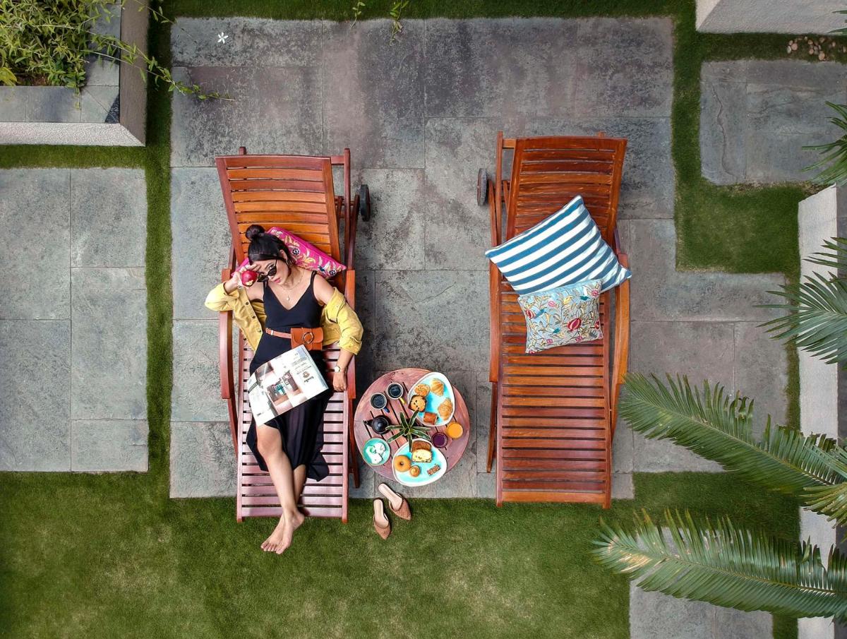 a woman sitting in a chair on a lawn at Hyatt Centric MG Road Bangalore in Bengaluru a woman sitting in a chair on a lawn at Hyatt Centric MG Road Bangalore in Bengaluru