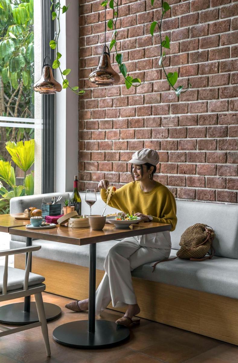 a statue of a woman sitting at a table at Hyatt Centric MG Road Bangalore in Bengaluru a statue of a woman sitting at a table at Hyatt Centric MG Road Bangalore in Bengaluru