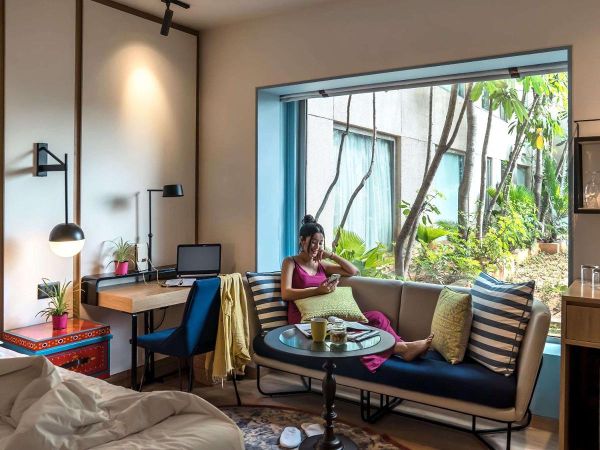 a woman sitting on a couch talking on a cell phone at Hyatt Centric MG Road Bangalore in Bengaluru a woman sitting on a couch talking on a cell phone at Hyatt Centric MG Road Bangalore in Bengaluru