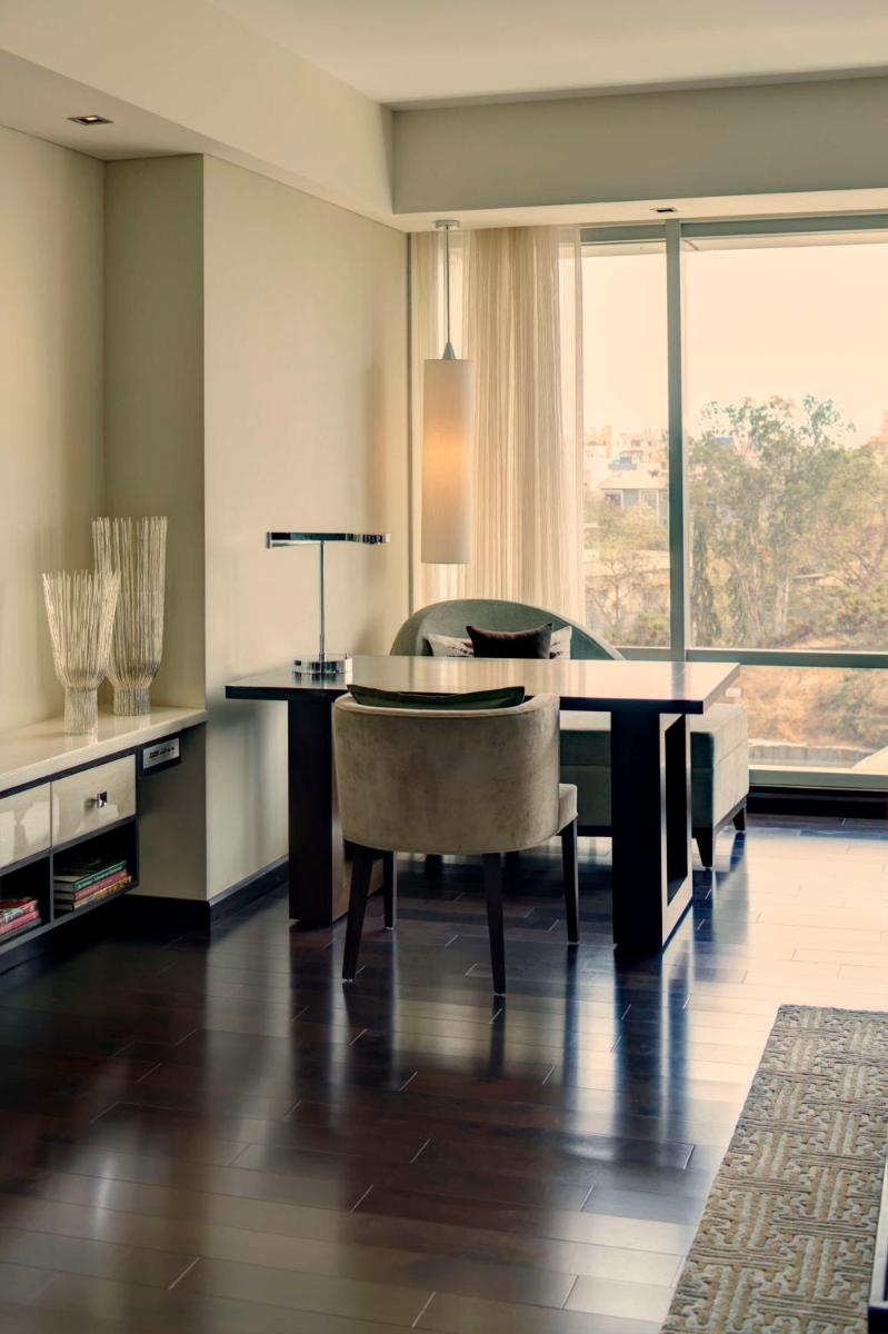 a dining room with a table and a chair at Park Hyatt Hotel and Residences, Hyderabad in Hyderabad