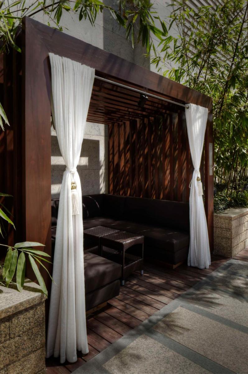 a living room with a couch and curtains at Park Hyatt Hotel and Residences, Hyderabad in Hyderabad