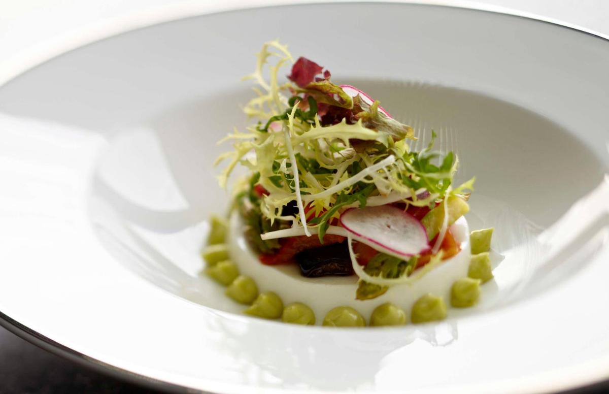 a plate of food with a salad in a bowl at Park Hyatt Hotel and Residences, Hyderabad in Hyderabad