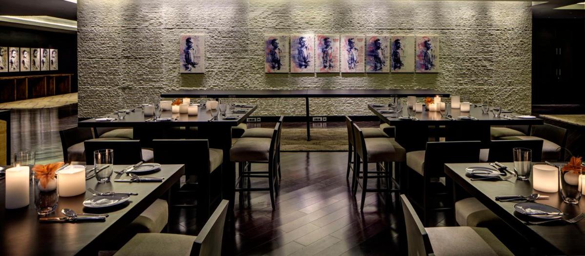 a restaurant with tables and chairs in a room at Park Hyatt Hotel and Residences, Hyderabad in Hyderabad