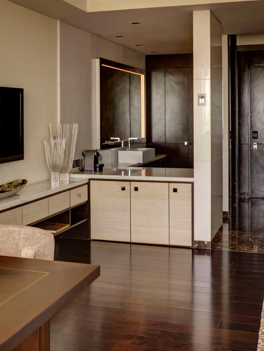 a large kitchen with wooden floors and stainless steel appliances at Park Hyatt Hotel and Residences, Hyderabad in Hyderabad