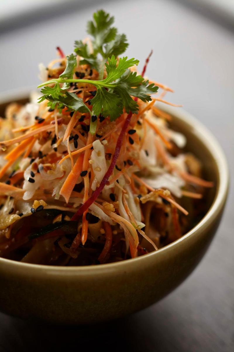 a bowl of food with carrots and other vegetables at Park Hyatt Hotel and Residences, Hyderabad in Hyderabad