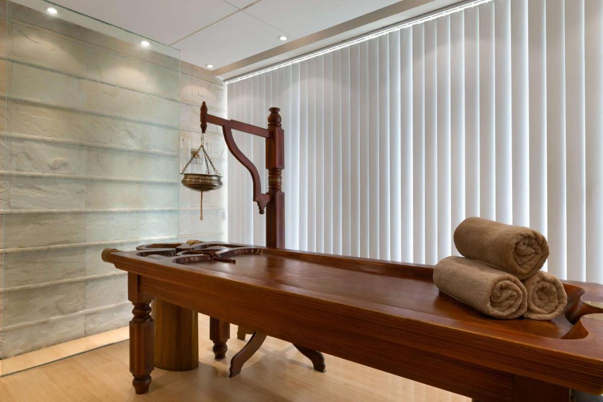 a wooden table with towels on it in a room at Hyatt Regency Kolkata in Kolkata a wooden table with towels on it in a room at Hyatt Regency Kolkata in Kolkata
