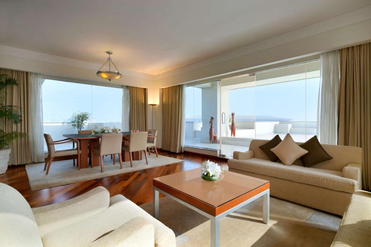 a living room with a couch and a table at Hyatt Regency Kolkata in Kolkata a living room with a couch and a table at Hyatt Regency Kolkata in Kolkata