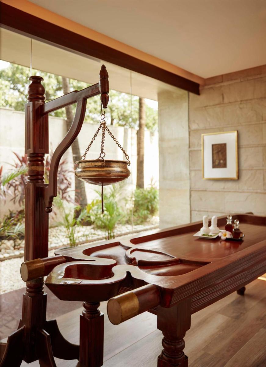 a room with a wooden table and a large window at Hyatt Regency Kolkata in Kolkata a room with a wooden table and a large window at Hyatt Regency Kolkata in Kolkata