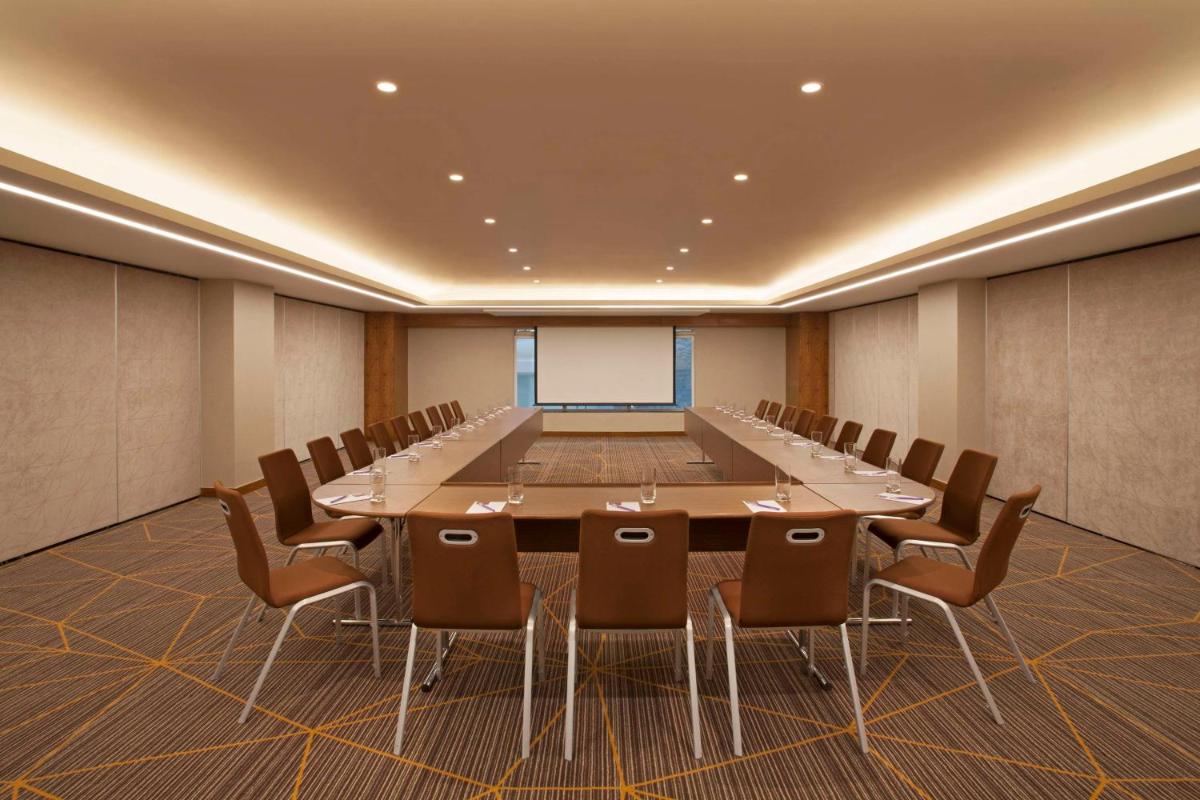 a conference room with a large table and chairs at Hyatt Place Hyderabad Banjara Hills in Hyderabad