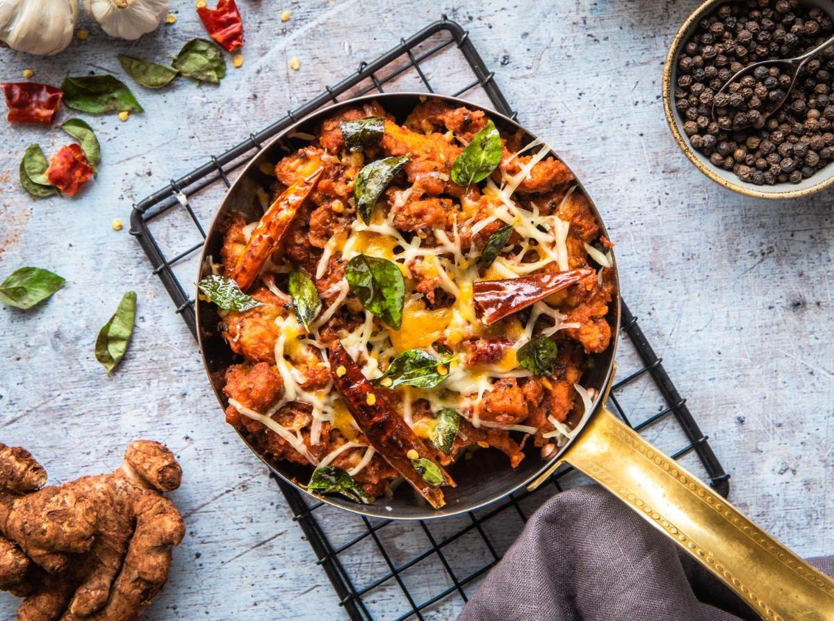 a pan filled with food on a cooling rack at Hyatt Place Hyderabad Banjara Hills in Hyderabad