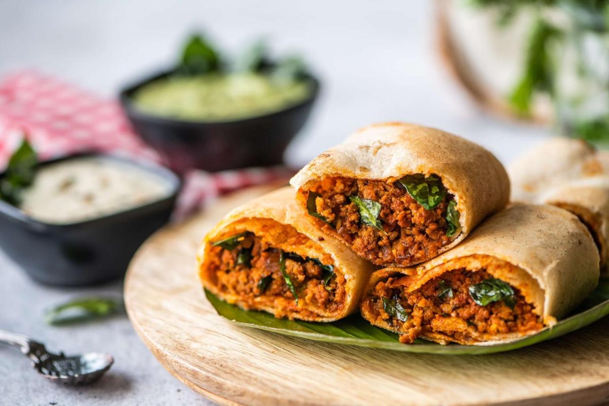 a plate with three meatball sandwiches on a table at Hyatt Place Hyderabad Banjara Hills in Hyderabad