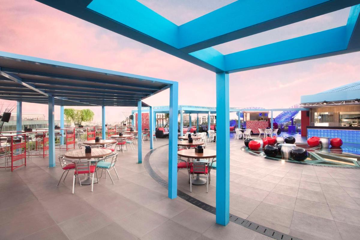 a rendering of the rooftop patio of a resort with tables and chairs at Hyatt Place Hyderabad Banjara Hills in Hyderabad