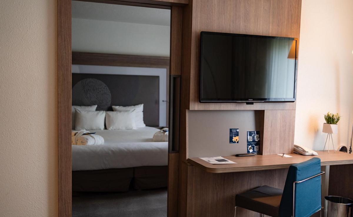 Un ou plusieurs lits dans un hébergement de l'établissement Novotel Fontainebleau Ury