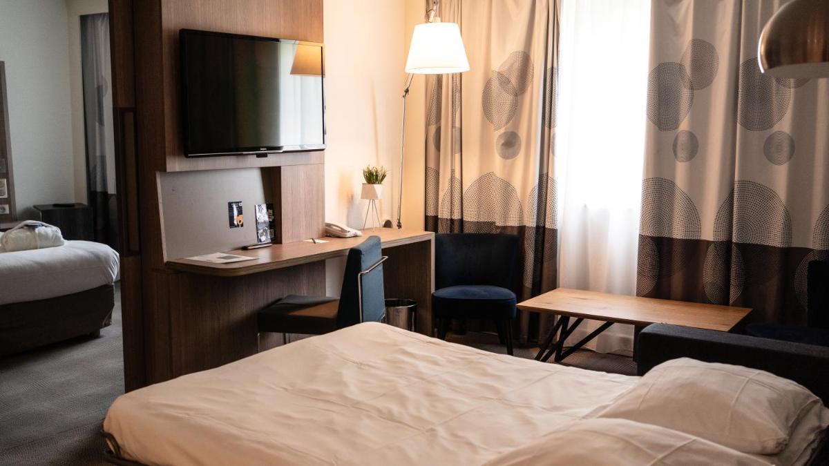 Un ou plusieurs lits dans un hébergement de l'établissement Novotel Fontainebleau Ury