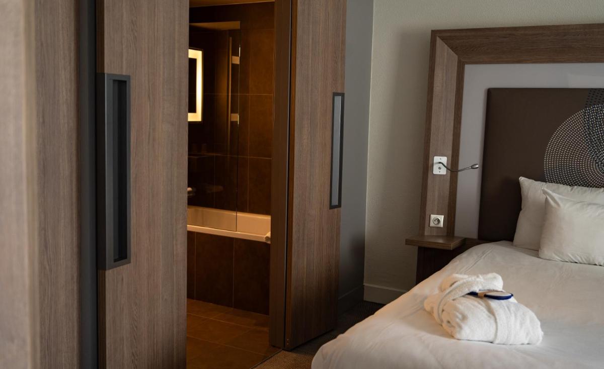 Un ou plusieurs lits dans un hébergement de l'établissement Novotel Fontainebleau Ury
