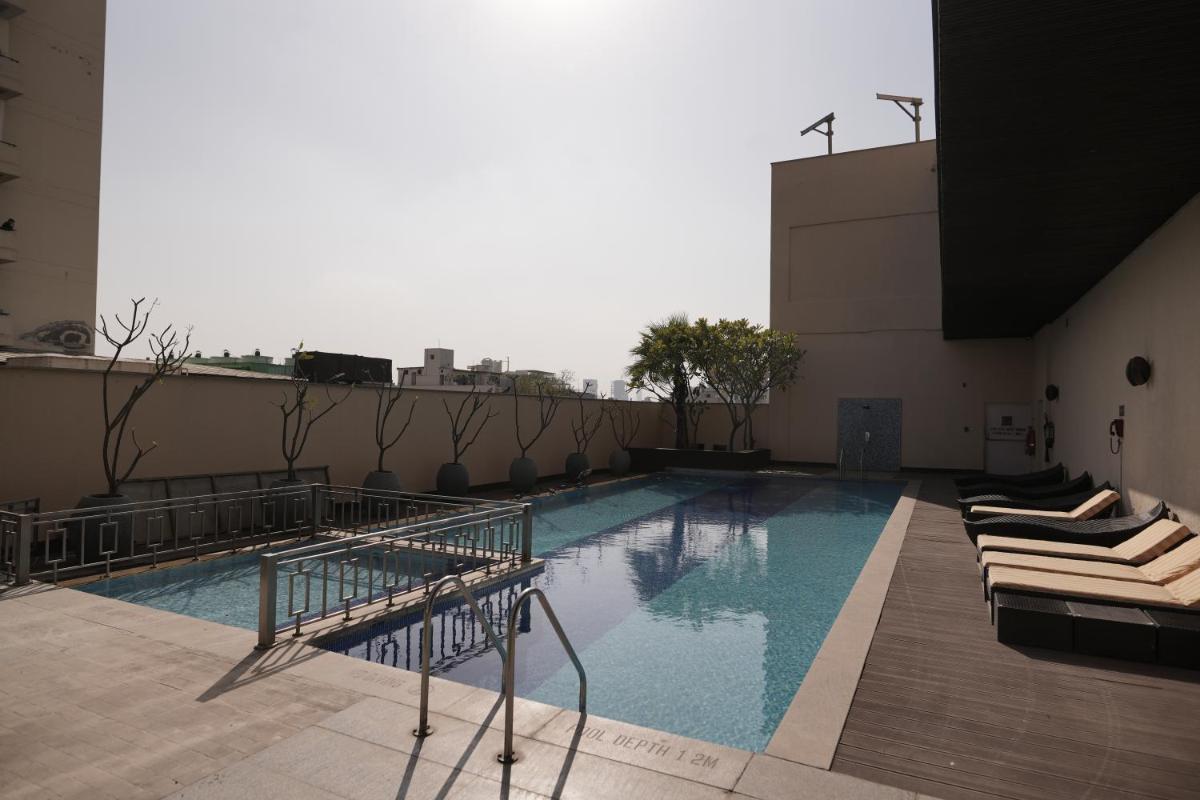a swimming pool on the roof of a building at DoubleTree by Hilton Gurgaon New Delhi NCR in Gurgaon