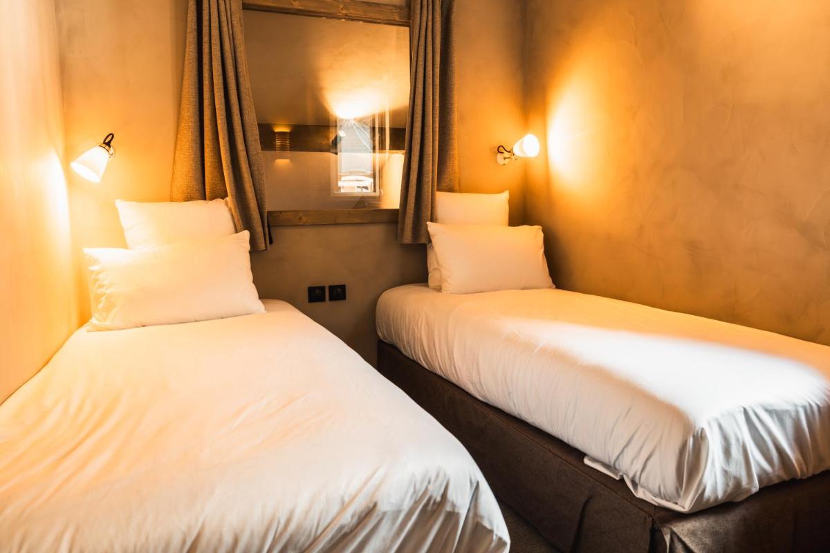 Un ou plusieurs lits dans un hébergement de l'établissement Hôtel de la Roche