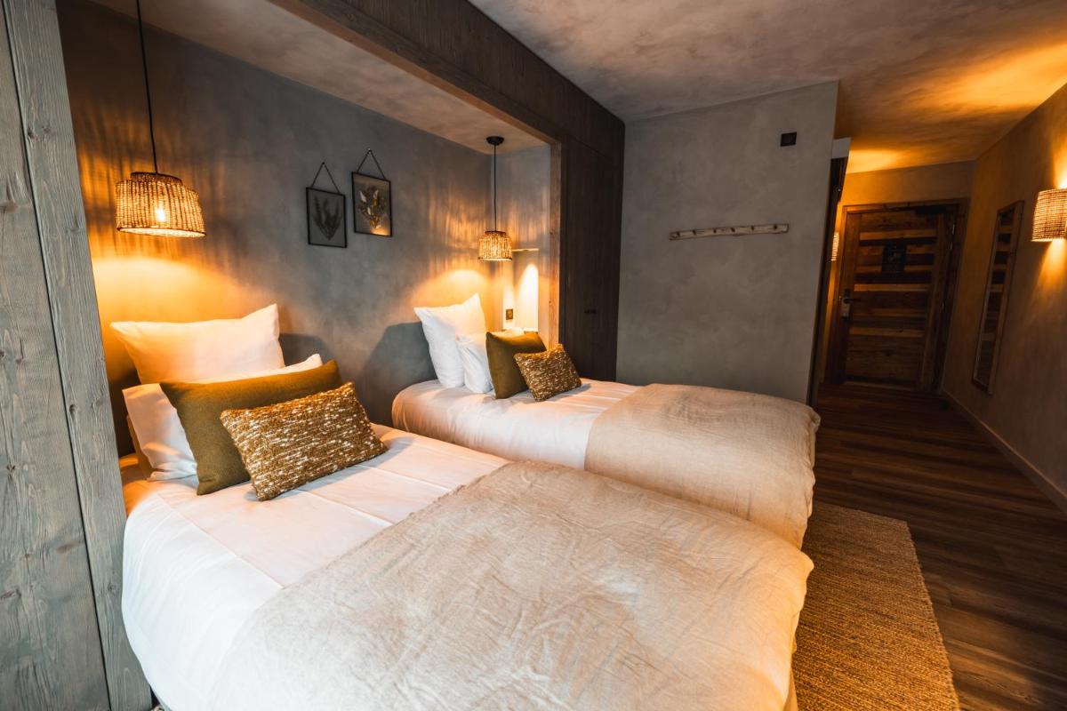 Un ou plusieurs lits dans un hébergement de l'établissement Hôtel de la Roche
