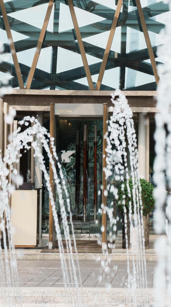 a building with a fountain in front of it at JW Marriott Hotel Kolkata in Kolkata