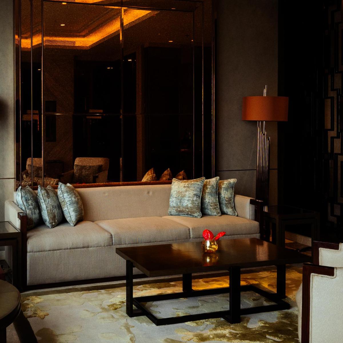 a living room with a couch and a coffee table at JW Marriott Hotel Kolkata in Kolkata