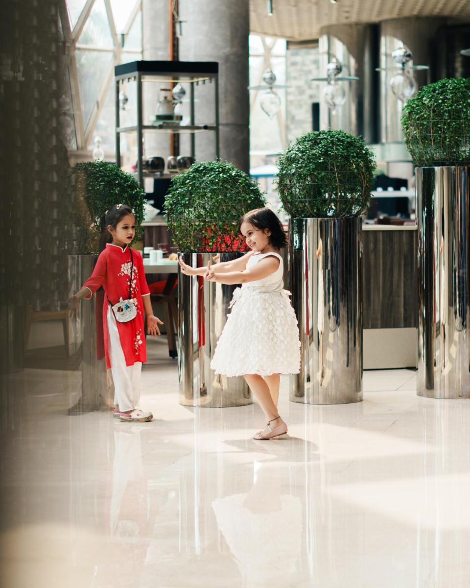 a young girl and a young boy standing in a building at JW Marriott Hotel Kolkata in Kolkata +104 photos