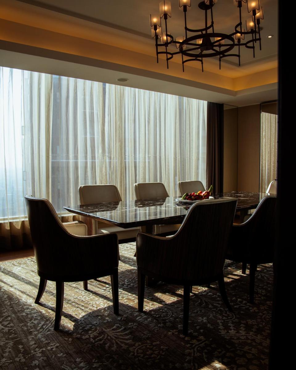 a dining room with a table and chairs at JW Marriott Hotel Kolkata in Kolkata
