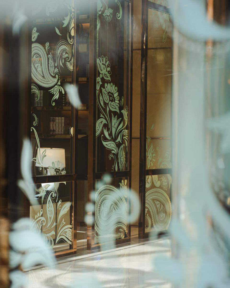 a reflection of a display case with china at JW Marriott Hotel Kolkata in Kolkata