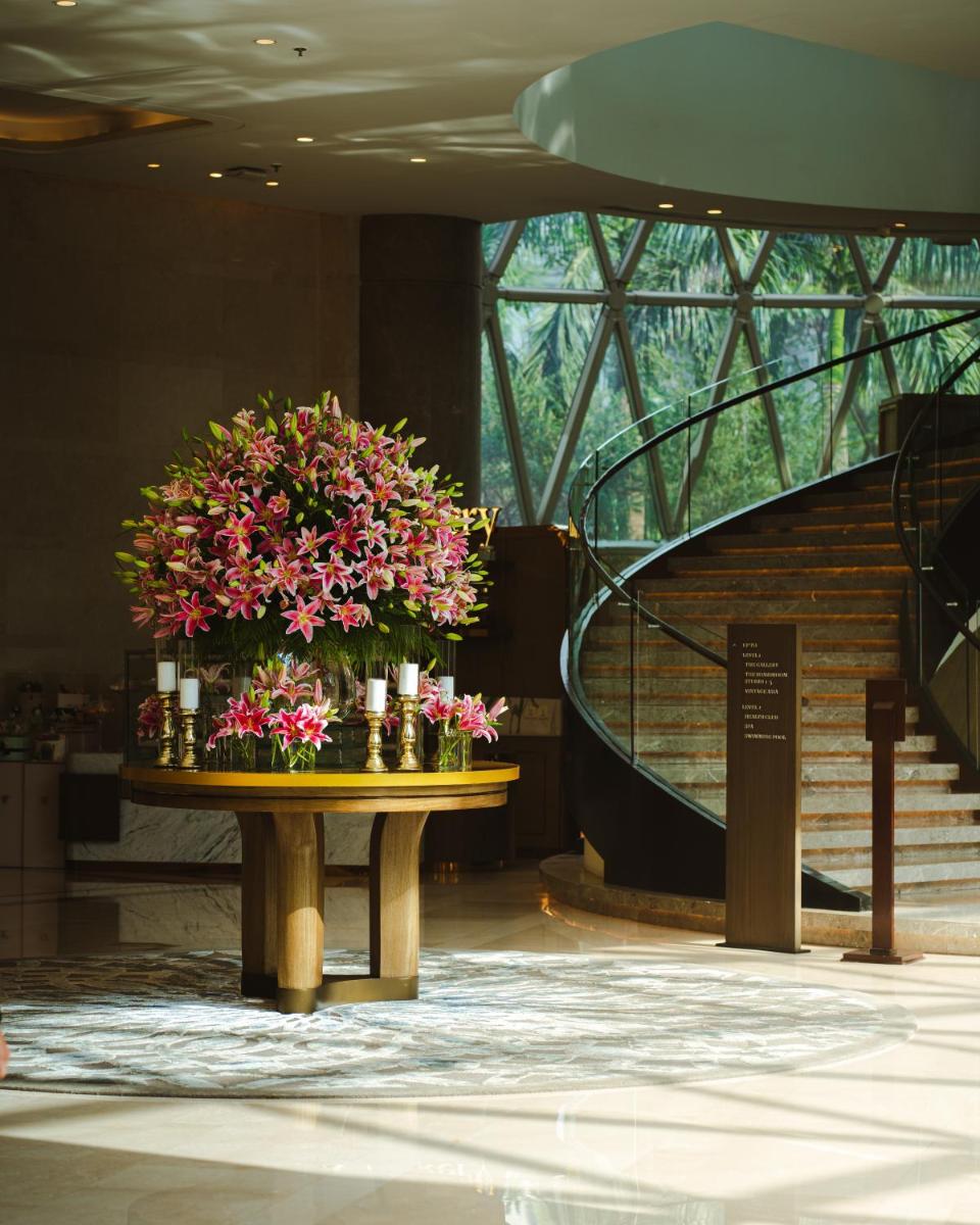a table with flowers on it in a building at JW Marriott Hotel Kolkata in Kolkata