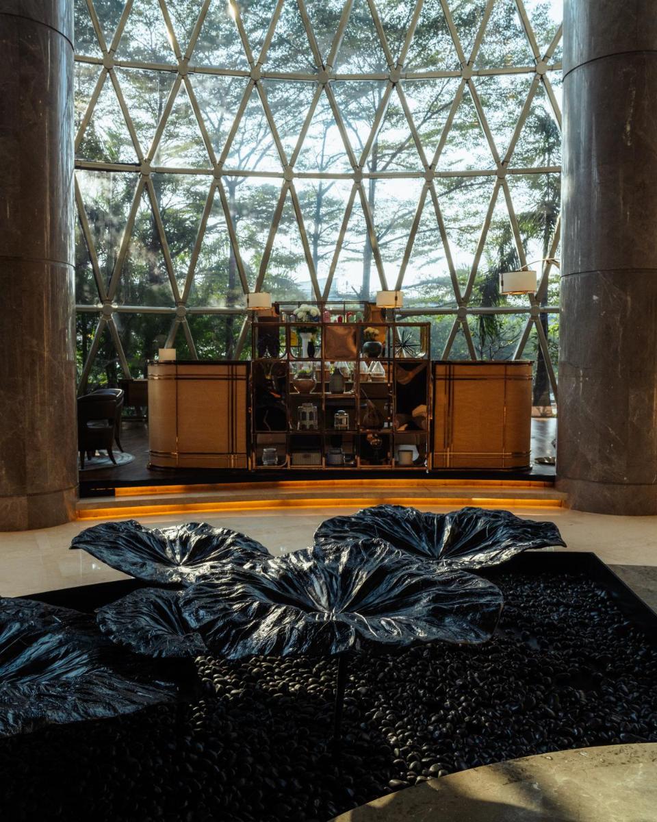 a large room with a large window and a black rug at JW Marriott Hotel Kolkata in Kolkata