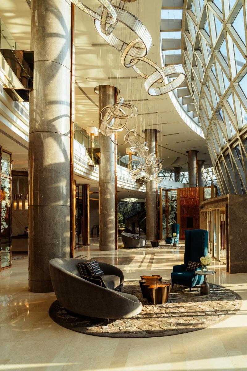 a lobby with a large tub in the middle of a building at JW Marriott Hotel Kolkata in Kolkata