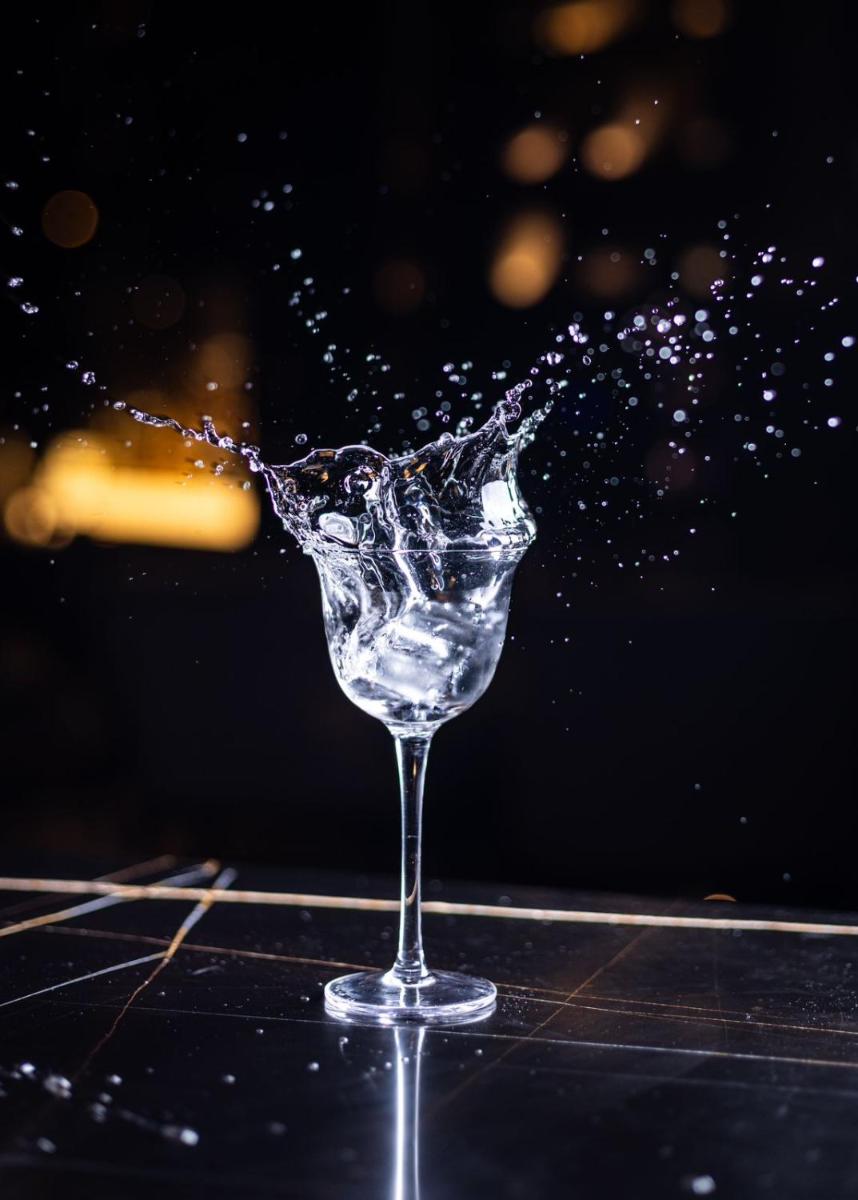 a glass being splashed with water on a table at JW Marriott Hotel Kolkata in Kolkata