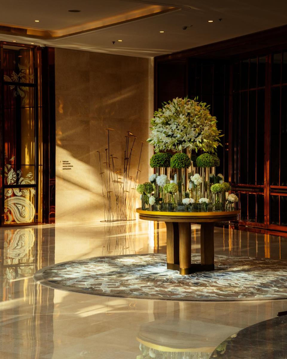a large arrangement of flowers on a table in a lobby at JW Marriott Hotel Kolkata in Kolkata