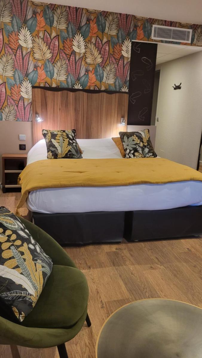 Un ou plusieurs lits dans un hébergement de l'établissement Hôtel Spa La Truite Dorée
