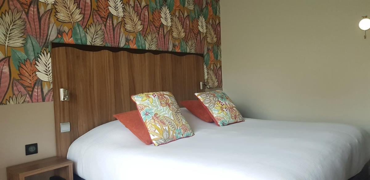 Un ou plusieurs lits dans un hébergement de l'établissement Hôtel Spa La Truite Dorée