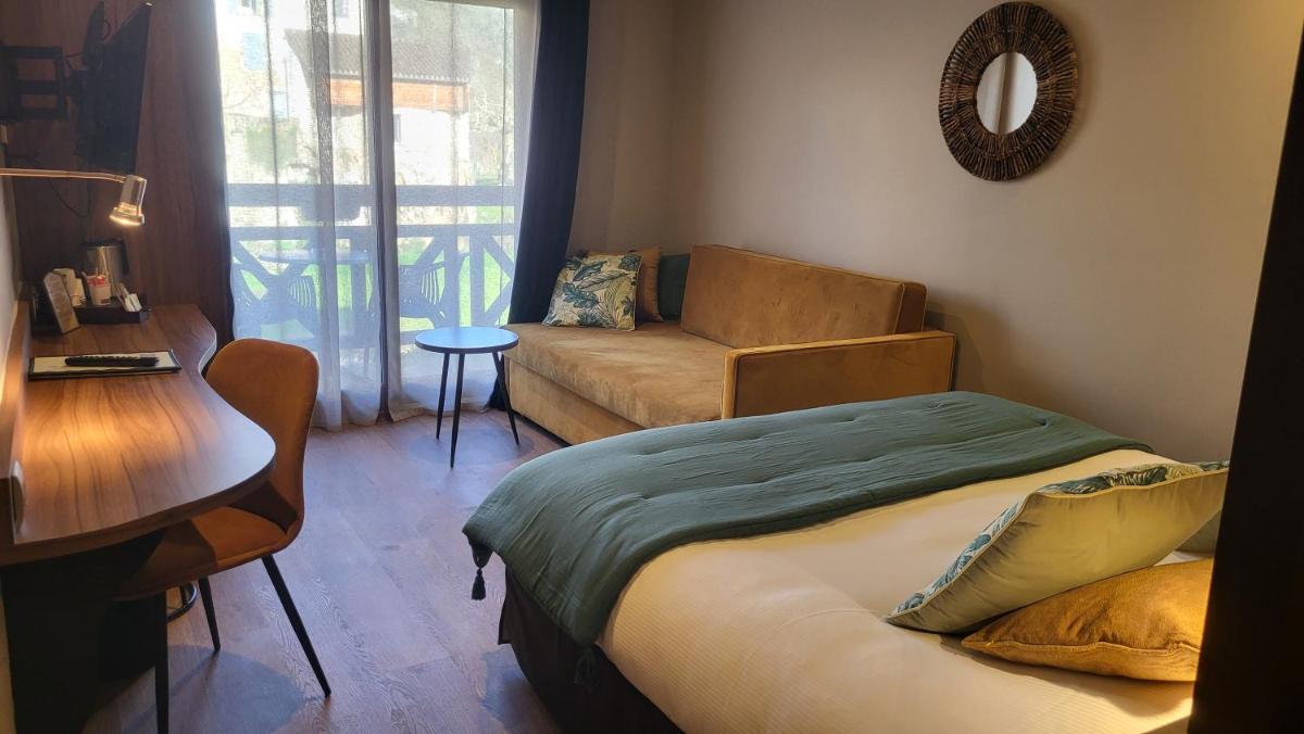 Un ou plusieurs lits dans un hébergement de l'établissement Hôtel Spa La Truite Dorée