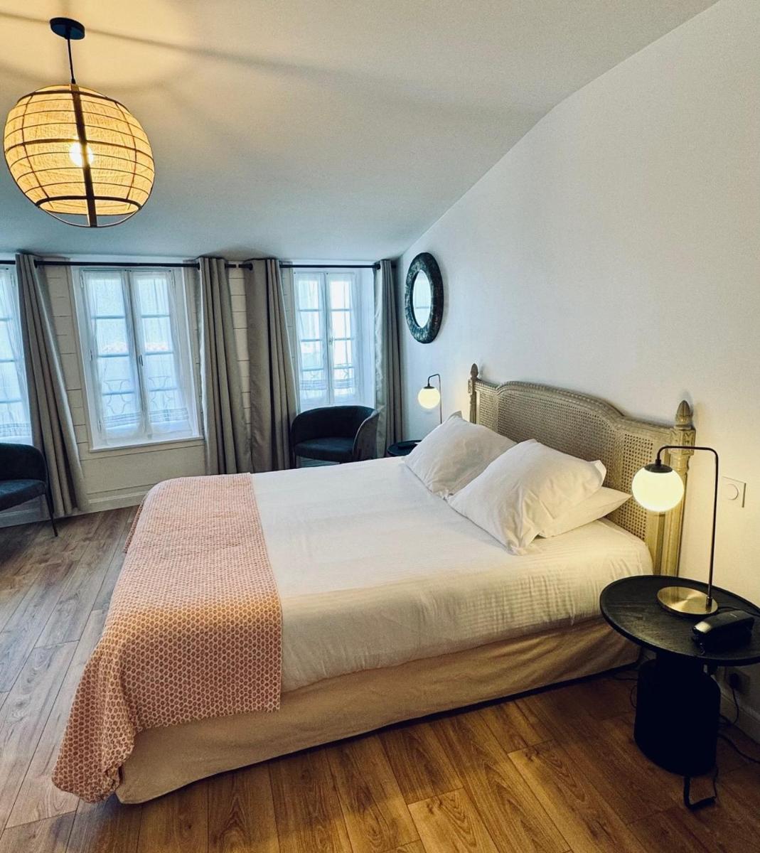 Un ou plusieurs lits dans un hébergement de l'établissement Hotel L'Océan