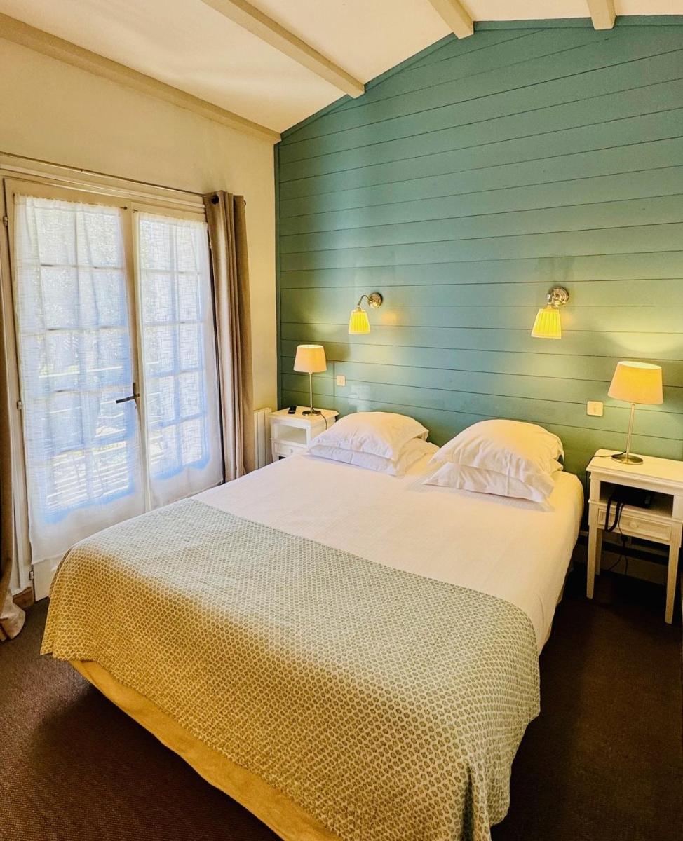 Un ou plusieurs lits dans un hébergement de l'établissement Hotel L'Océan