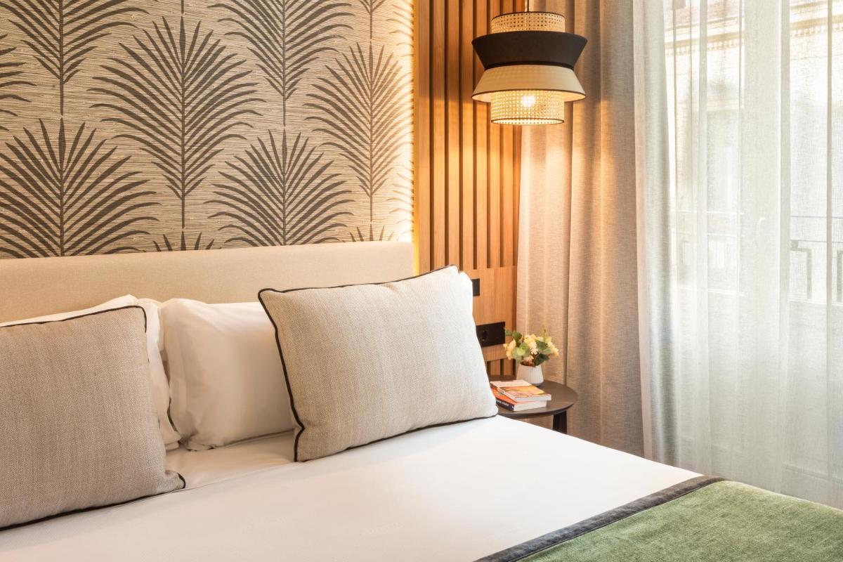 Cama o camas de una habitación en Catalonia Atocha
