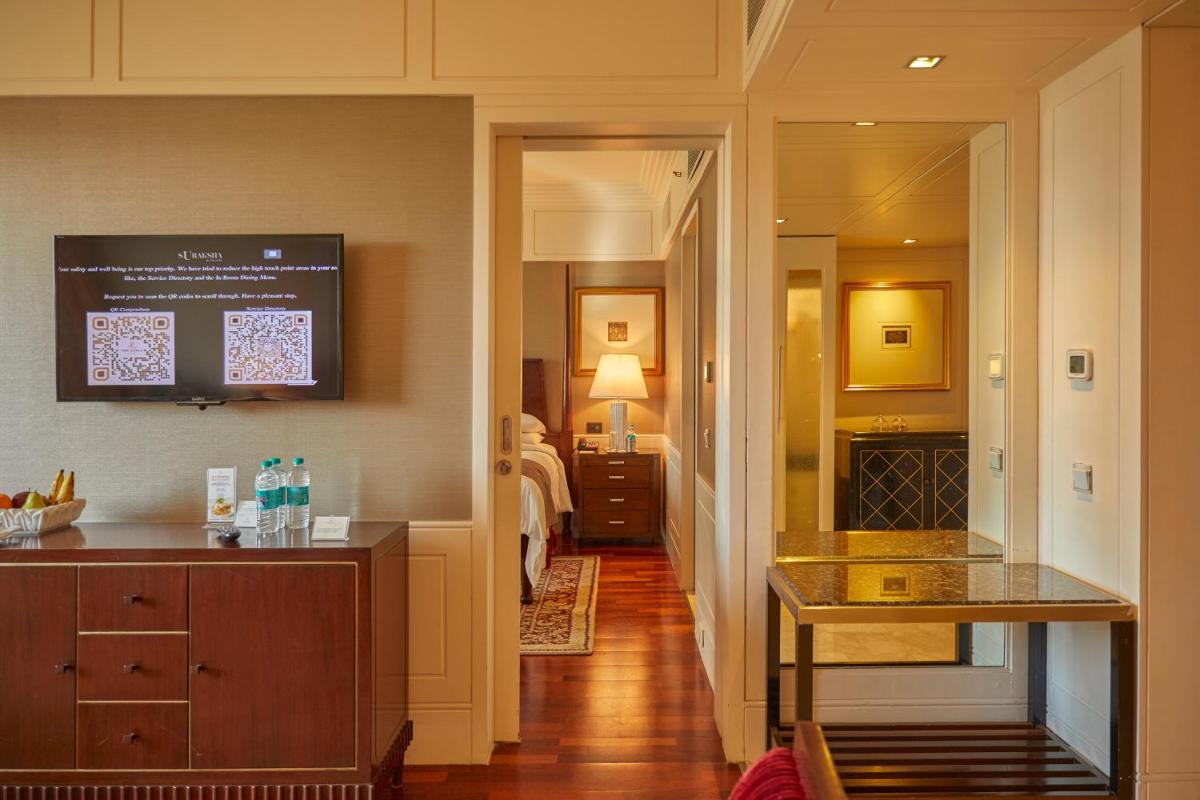 a hotel room with a kitchen and a bedroom at The Leela Mumbai in Mumbai a hotel room with a kitchen and a bedroom at The Leela Mumbai in Mumbai