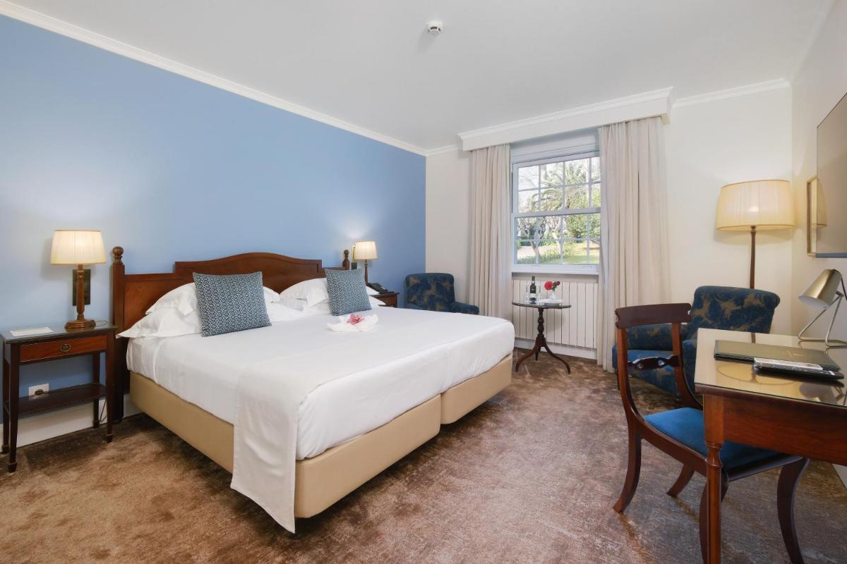 Uma cama ou camas num quarto em Casa Velha do Palheiro Relais & Chateaux