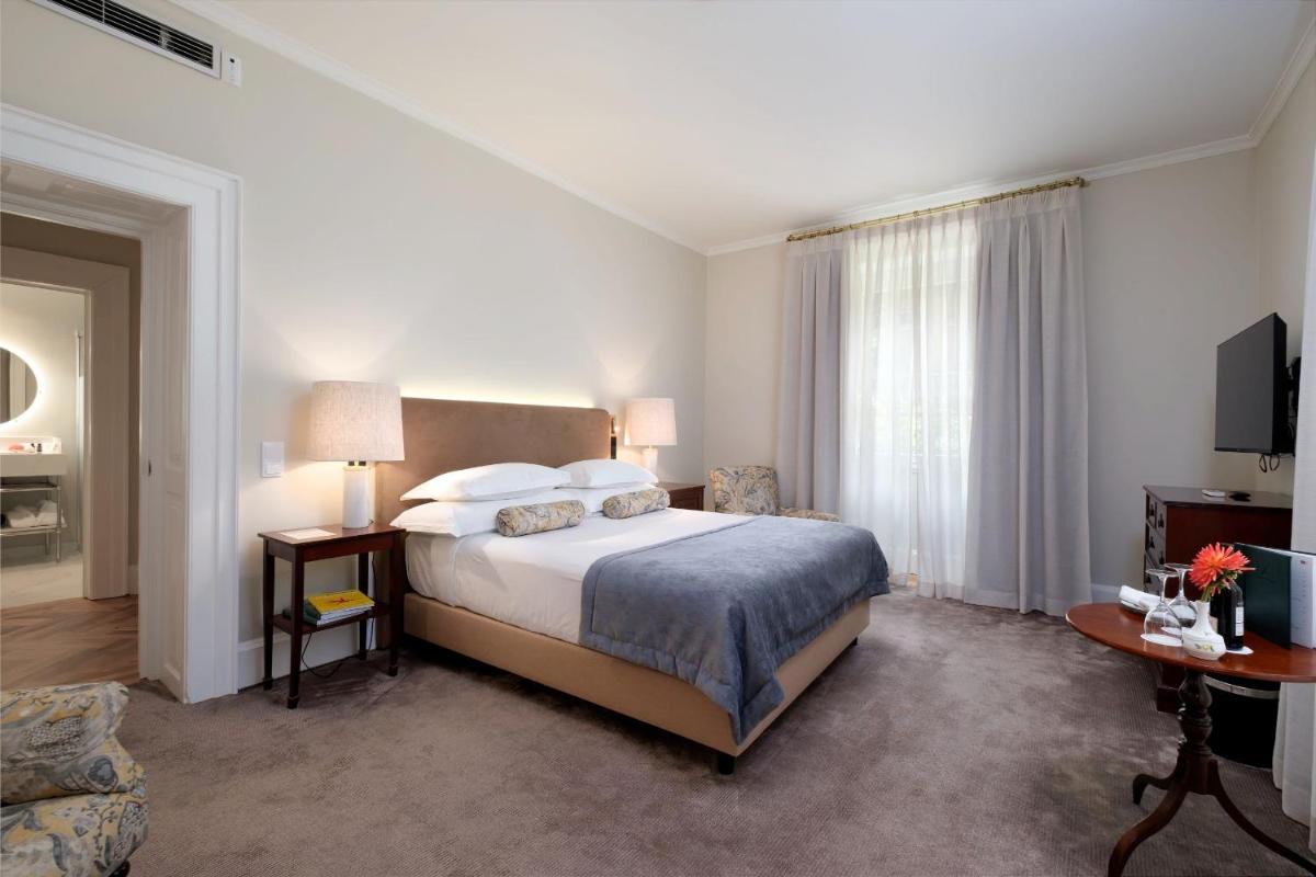 Uma cama ou camas num quarto em Casa Velha do Palheiro Relais & Chateaux
