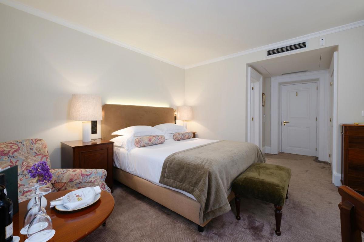 Uma cama ou camas num quarto em Casa Velha do Palheiro Relais & Chateaux