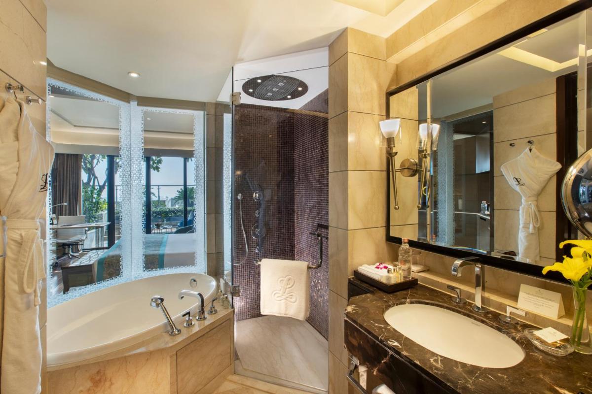 a bathroom with a tub and a sink at The Leela Ambience Convention Hotel Delhi in New Delhi