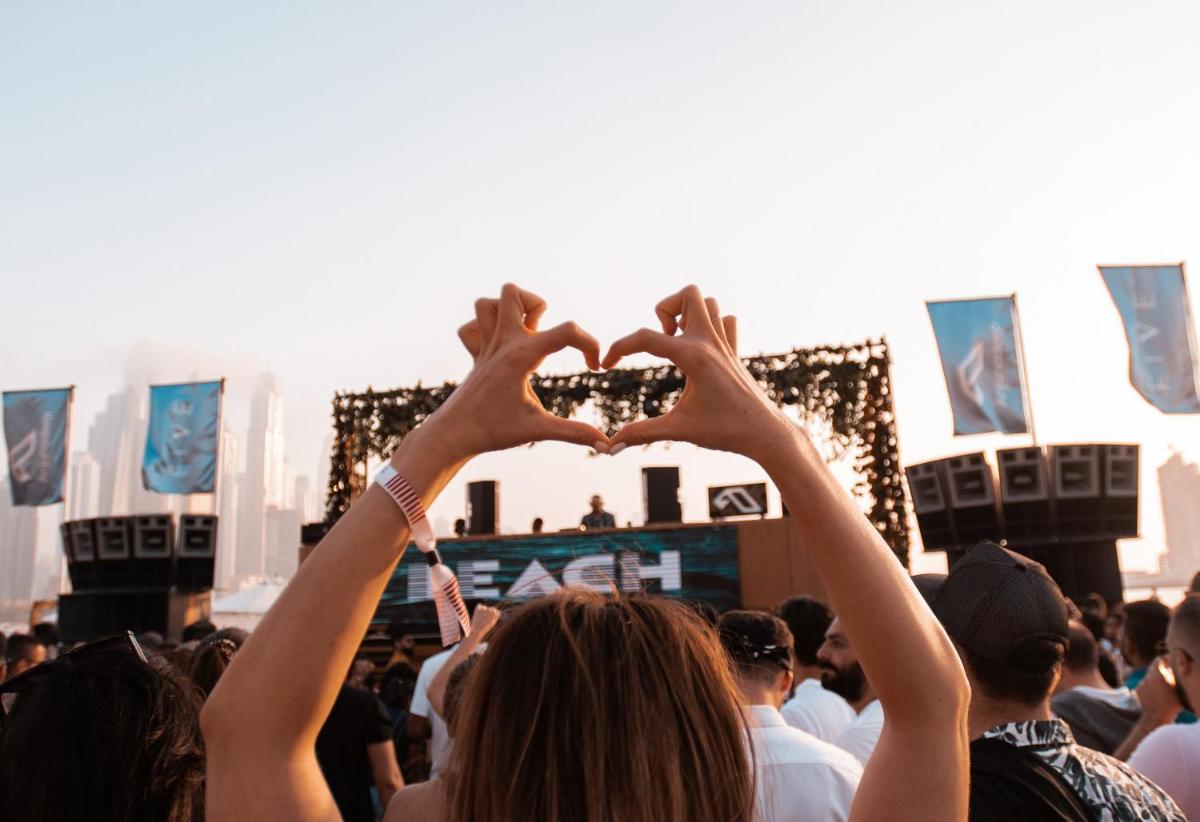 a crowd of people making a heart sign with their hands at FIVE Palm Jumeirah Dubai in Dubai