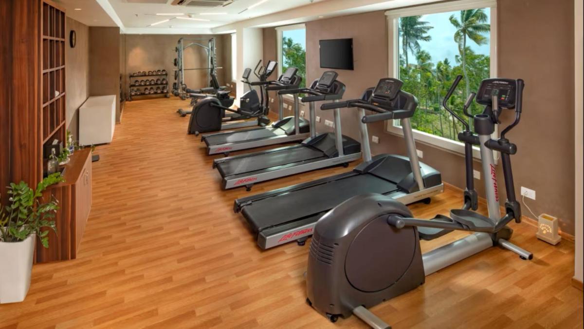 a row of exercise bikes in a gym at O by Tamara, Trivandrum in Trivandrum