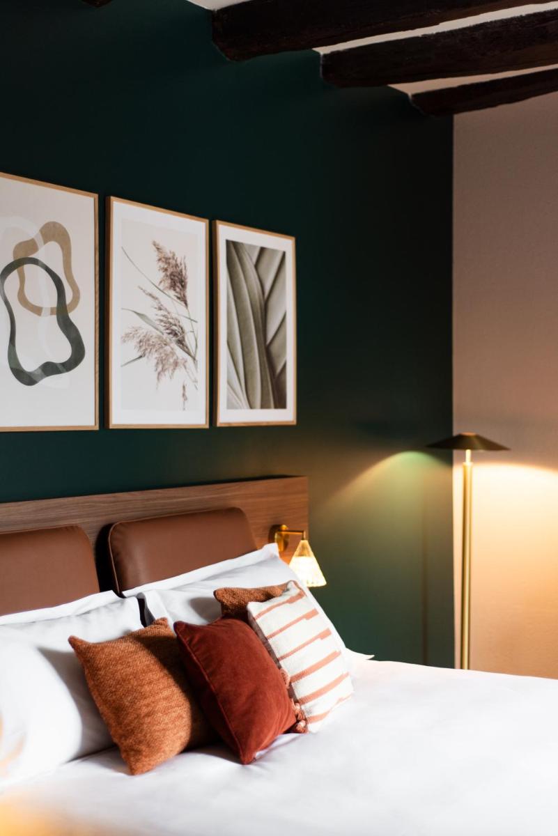 Un ou plusieurs lits dans un hébergement de l'établissement La Maison OBONO Hôtel & Spa
