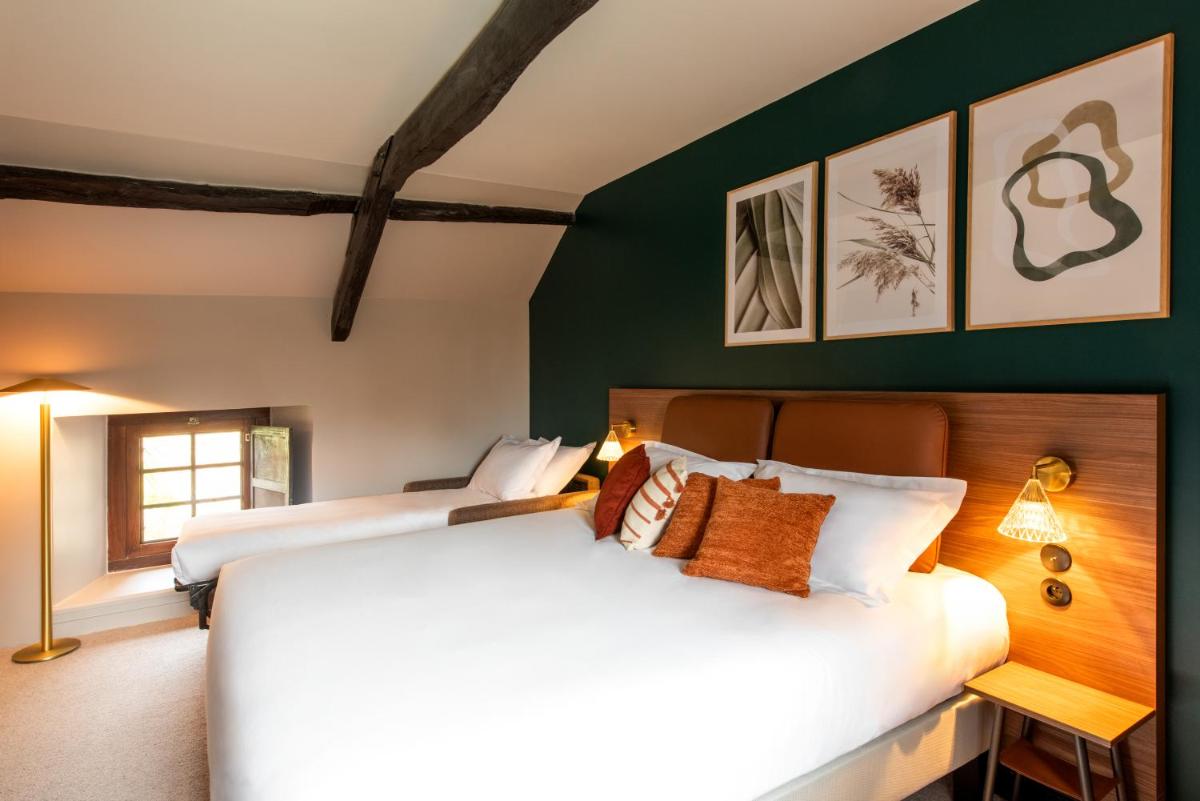 Un ou plusieurs lits dans un hébergement de l'établissement La Maison OBONO Hôtel & Spa