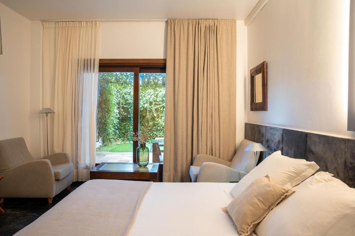 Cama o camas de una habitación en Hotel Boutique Mas Passamaner