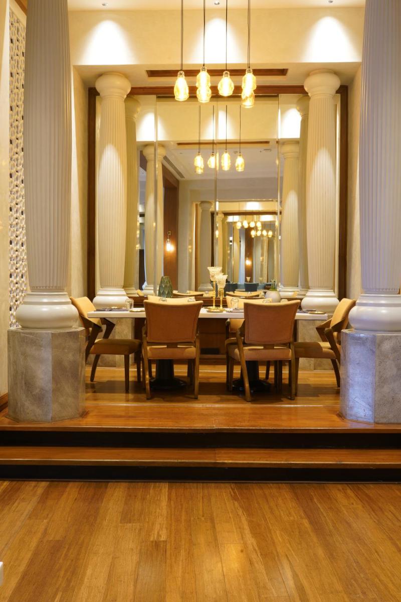 a large dining room with a table and chairs at The Westin Mumbai Powai Lake in Mumbai