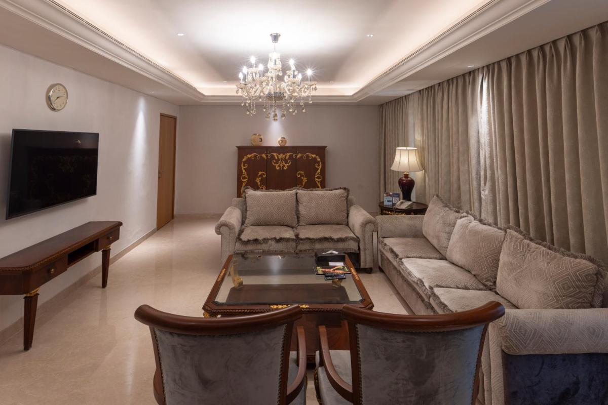 a living room with a couch and a table at Novotel Hyderabad Airport in Hyderabad